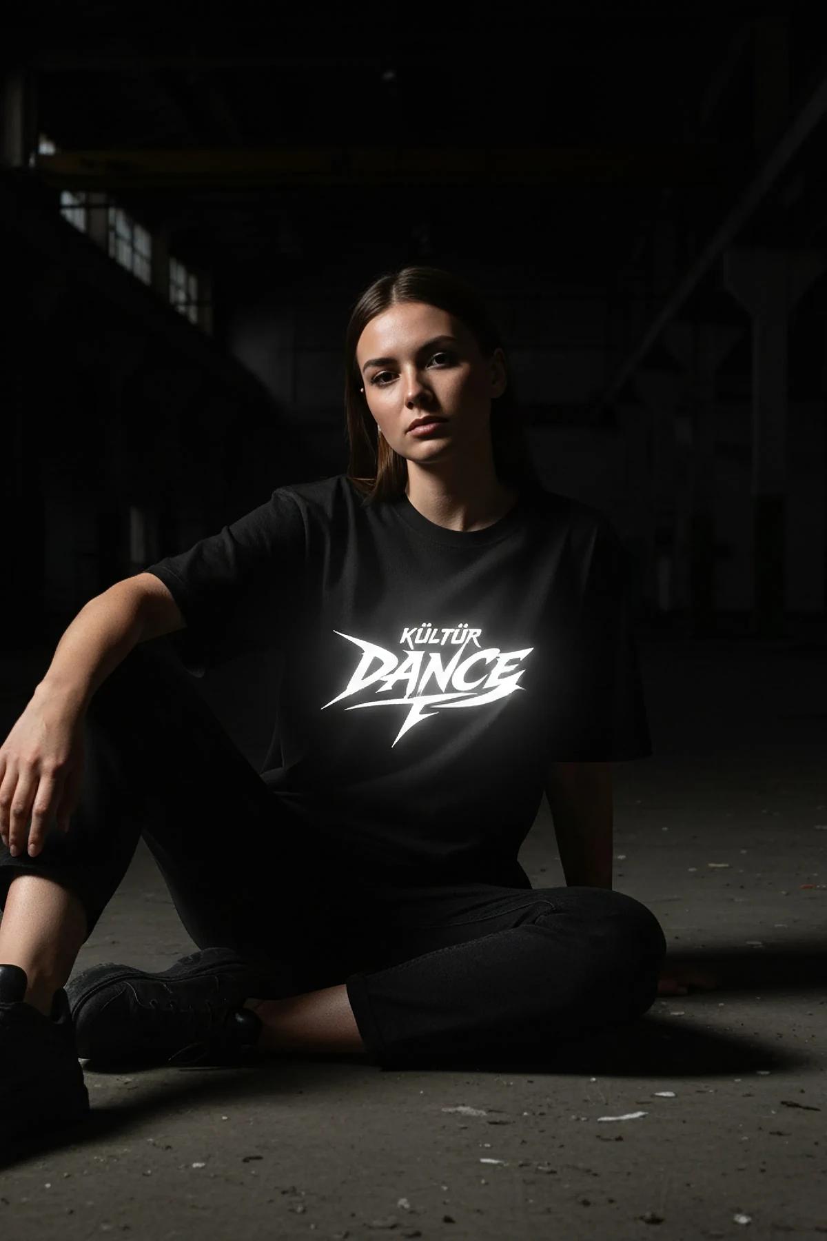 black oversized reflective graphic t-shirt with white Kültür Dance angular print centered on chest