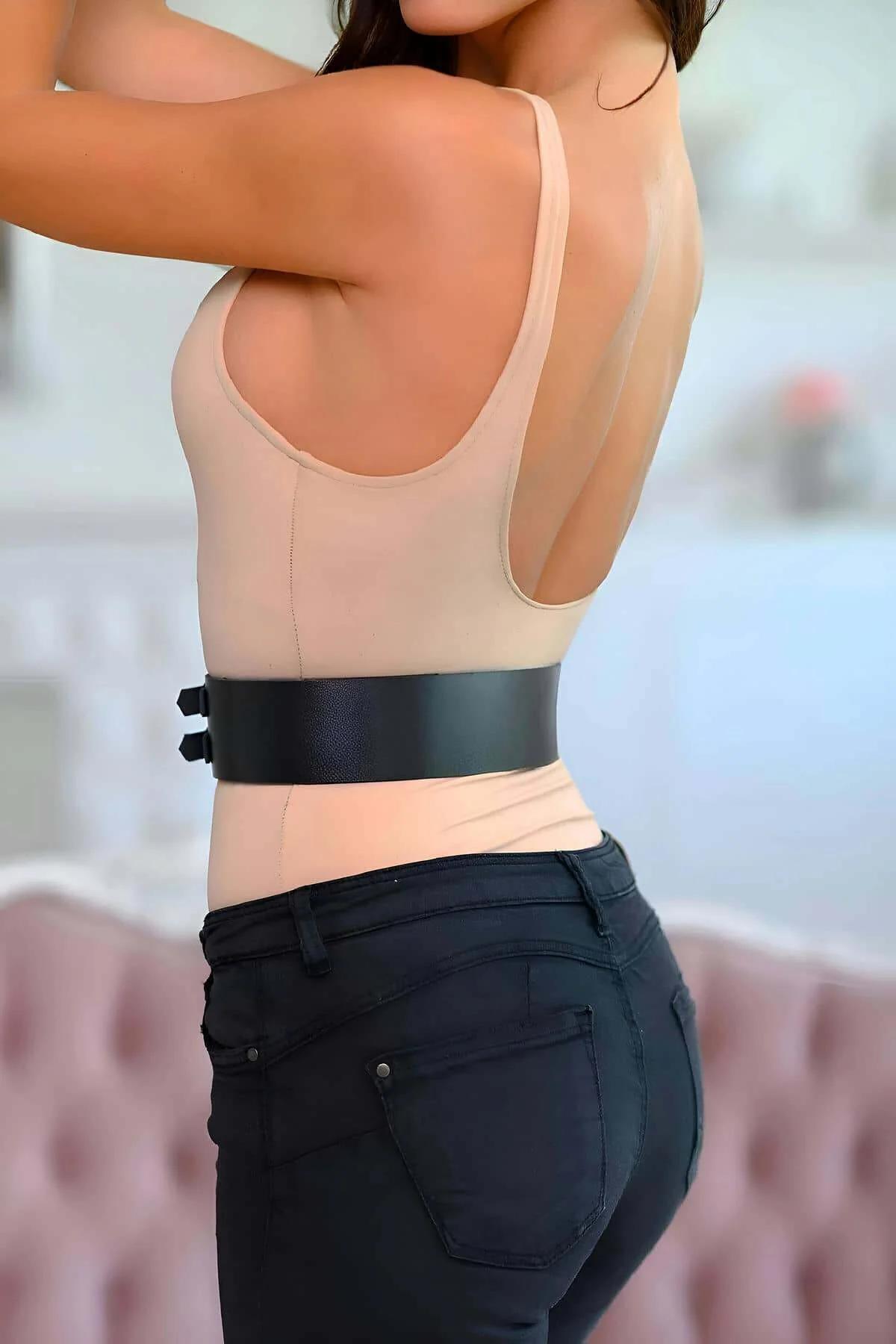 geniş siyah korse kemer bej body ve siyah pantolon kombini üzerinde