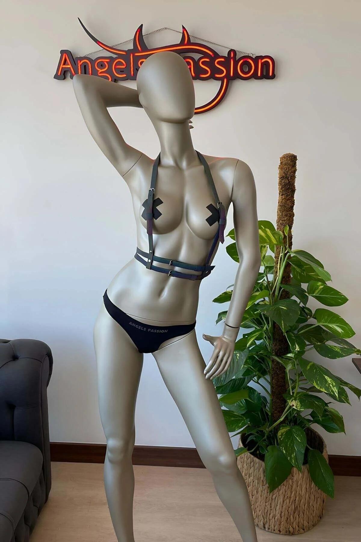 Festival sahne aydınlatmasında yeşil ve pembe tonları yansıtan gökkuşağı holografik harness bölmeleri